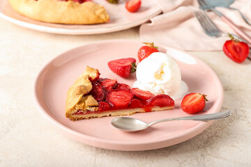 Plate with tasty strawberry pie and ice cream on light background