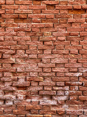 Horizontal part of a Venetian old red brick wall, background,