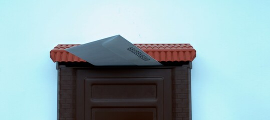 A letter in the mail receiver in a brown mailbox on a white background