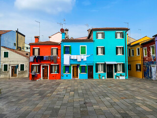 Fototapeta na wymiar Colorful houses on a small traditional square at Burano island, Venice, Italy