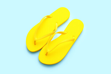 Stylish flip-flops on color background