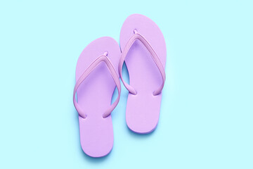 Stylish flip-flops on color background
