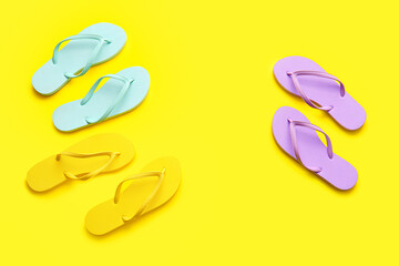 Set of stylish flip-flops on color background