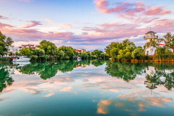 Sunset in River Manavgat with purple cloud and tree reflection. 