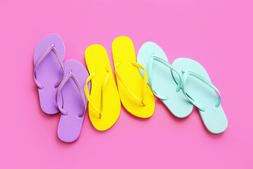 Stylish flip-flops on color background