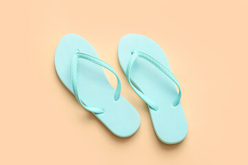 Stylish flip-flops on color background