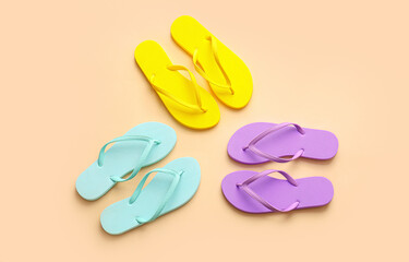 Set of stylish flip-flops on color background