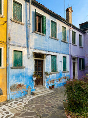 Fototapeta na wymiar Multicolored houses on a little square at Burano island, Venice, Italy