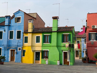 Multicolored houses on a little square at Burano island, Venice, Italy