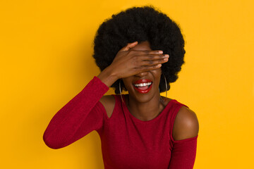 Fototapeta na wymiar Elegant Young Black Woman Is Covering Hers Eyes And Laughing