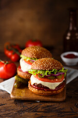 Traditional homemade cheeseburgers with pickles