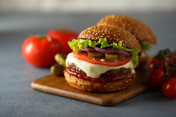 Traditional homemade cheeseburgers with pickles