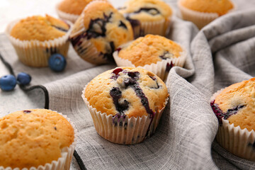 Tasty blueberry muffins on table, closeup