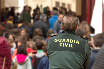 A Spanish civil guard watches a peaceful manifestation