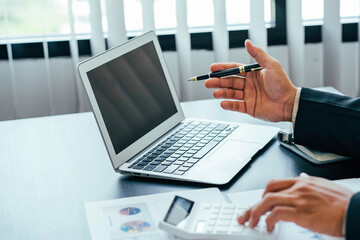 businessman working on the desk with using calculator and computer in the office. concept accounting finance and invest