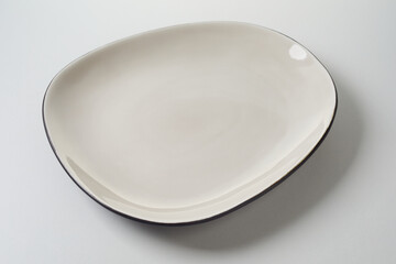 Beige plate of uneven shape