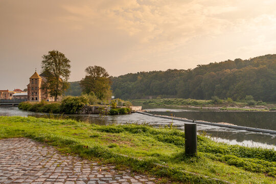 River Mulde near Grimma in Saxony with building "Grossmuehle", german for large mill, in background in evening light