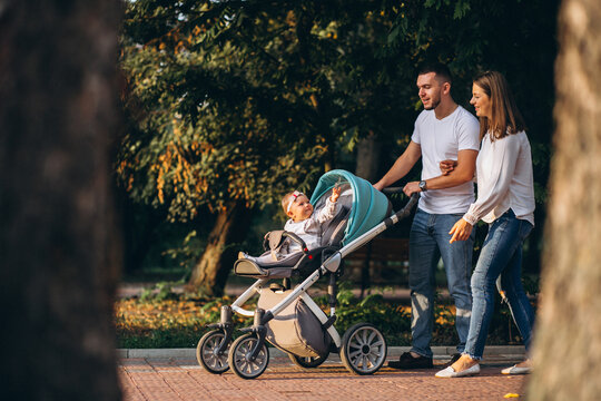 Young family with their small daughter in autumn park
