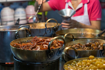 Tao Tung shop on Yaowarat Road, Bangkok, Thailand. It is a kind of Chinese dessert, consisting of syrup lotus root, goji seeds, Chinese jujube, etc., topped with syrup made from dried longan.