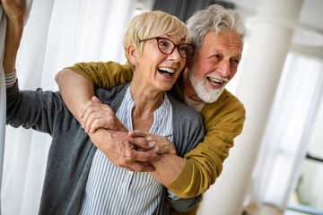 Happy senior couple in love hugging and bonding with true emotions