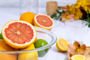 Colorful citrus fruits in a glass bowl.