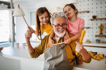 Grandchildren having fun, playing with grandparents at home
