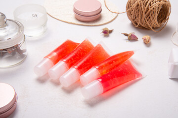 Set of homemade lip gloss on wooden desk