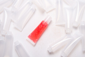 Lot of plastic empty tubes for   homemade lip gloss on wooden desk