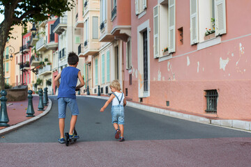 Children, riding scooter in Monaco Ville