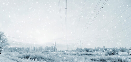 Long lines of power line towers stretching across a Winter Landscape.