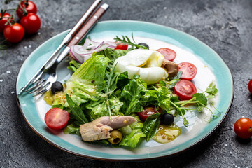 Tuna Fish Salad with poached, egg, lettuce, cherry, tomatoes olives and Corn. Restaurant menu, dieting, cookbook recipe