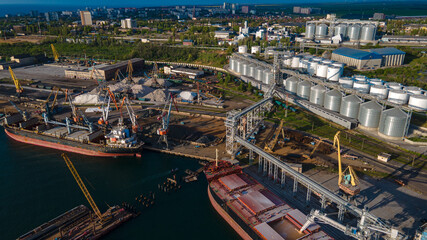 Fototapeta premium Industrial port in the field of import-export global business logistics and transportation, Loading and unloading container ships, cargo transportation from a bird's eye view.