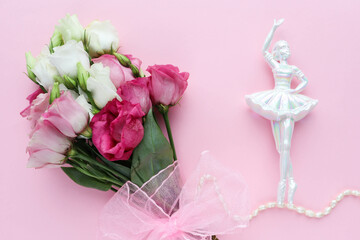 figurine of a ballerina girl isolated on a white background, flower and envelope. place for text