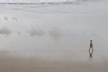 Fototapeta na wymiar Person walking on the beach