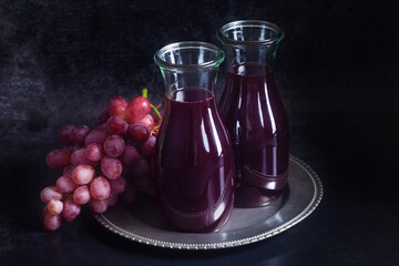 Red grape juice in a glass carafes