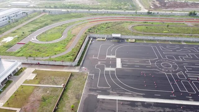 Aerial view of automotive factory with asphalt road that serves to test new vehicles