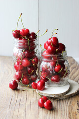 Merry. Berries in a jar on a wooden background. The concept of home preparations.