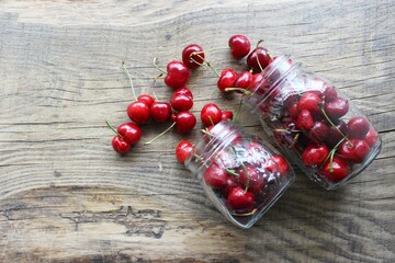 Merry. Berries in a jar on a wooden background. The concept of home preparations.