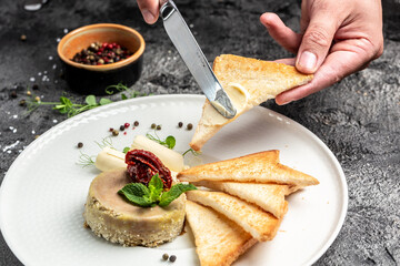 Pate. male hand greases toasted bread with butter and pate. Chicken liver pate with bread. Food...