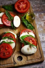 Delicious caprese sandwiches on a wooden board. Keto sandwiches. Italy diet.