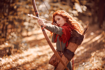 girl archer shooting in woods - obrazy, fototapety, plakaty