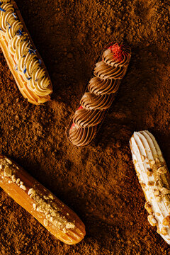 Artisan french Eclairs on cocoa powder texture