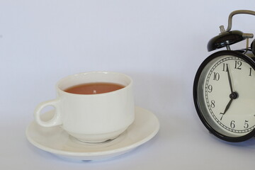 a cup of tea with alarm clock