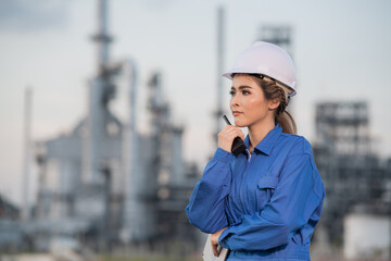 Engineers woman holding radio, report schedule for workers security control at power plant energy industry, Engineer Concept,professional,safety.