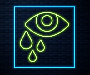 Glowing neon line Tear cry eye icon isolated on brick wall background. Vector