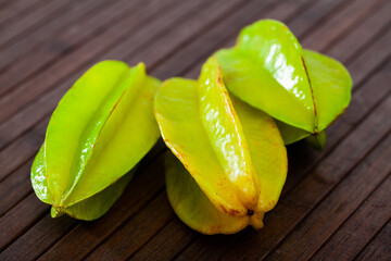 Juicy cannon fruits on a wooden desk in kitchen, nobody