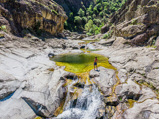 Man standing in front of the Chassezac river, Lozere, Cevenne, France