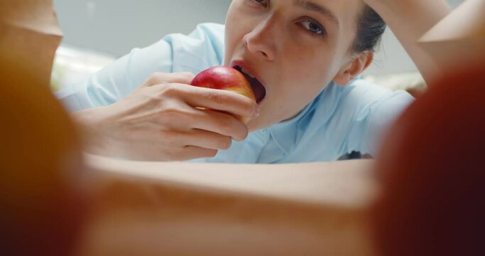 Inside view of craft paper bag with woman taking apple