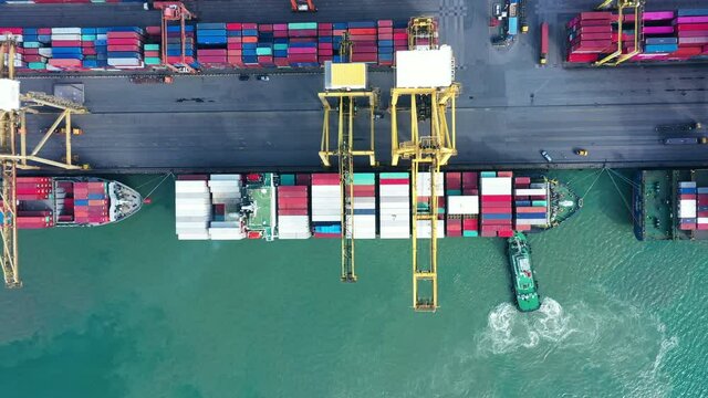 Aerial view of cargo container ship drage by tug boat to international terminal yard port  concept freight shipping by ship