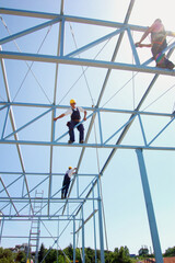 Unrecognizable Iron Constructions Workers on Site Reconstruction